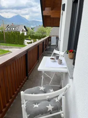 a balcony with a table and chairs on a porch at Hiša Višnar in Bled