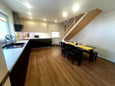 a kitchen and dining room with a table and chairs at Apartma DAVID in Zgornje Gorje