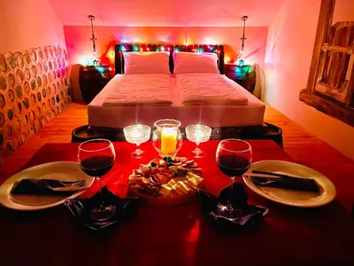 a room with a bed and a table with wine glasses at Vamiš in Gornji Petrovci