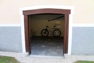 a bike parked inside of a garage at Apartments in Stari trg ob Kolpi - Süd-Ost Slowenien 42908 in Stari Trg ob Kolpi