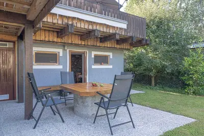 a wooden table and chairs on a patio at Apartments in Stari trg ob Kolpi - Süd-Ost Slowenien 42908 in Stari Trg ob Kolpi