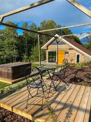 a patio with a table and chairs on a deck at Wellness hiška Robida in Ljutomer