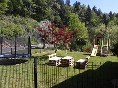 a playground with a swing set and a trampoline at Apartmaji Tisa in Žana in Rovte