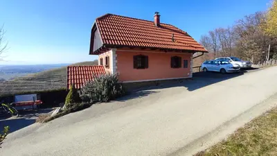 a small house on the side of a road at Apartman Vesna in Veliki Vrh