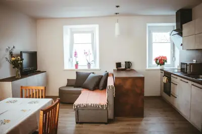 a small living room with a couch and a table at Apartma Moser in Podnanos