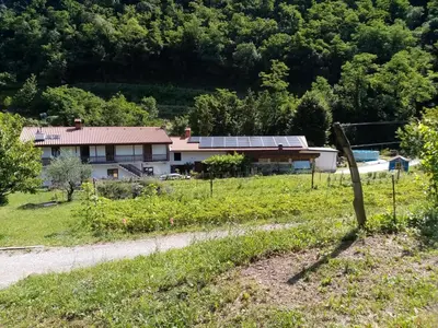a house with solar panels on the side of a road at Apartma Moser in Podnanos