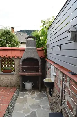 an outdoor oven on the side of a building at Holiday Home Ribno - Bled in Bled