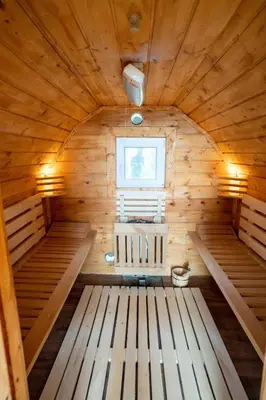 a sauna with wooden floors and a window at Glamping hišice Orlič in Muta