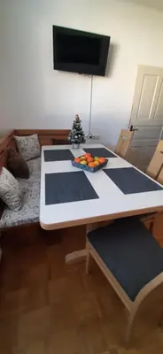 a dining room table with blue and white mats at Apartma Dana-Brinjtesa in Jesenice