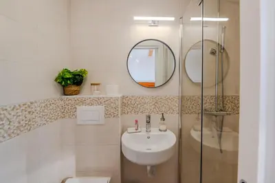 a bathroom with a sink and a mirror at Rooms&Vinery Bregovi - Sobe in vinska klet Bregovi in Dobravlje