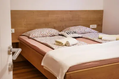 two twin beds with pillows on them in a bedroom at Metropolitana's Zois Apartments in Bohinj