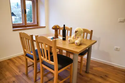 a teddy bear sitting on top of a wooden table at Metropolitana's Zois Apartments in Bohinj