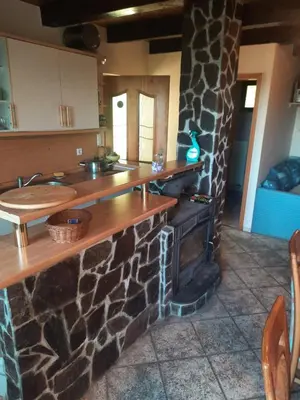 a kitchen with a stone counter and an oven at Pocitniska hisa na Pohorju in Pohorje