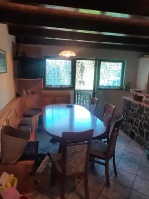 a dining room with a table and chairs at Pocitniska hisa na Pohorju in Pohorje