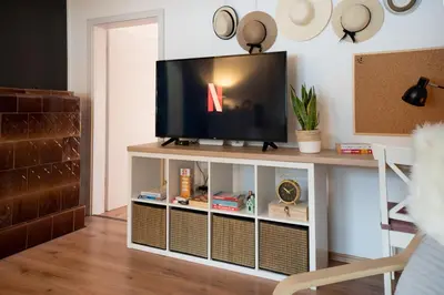 a television on a stand in a living room at Hygge House Bled in Bled