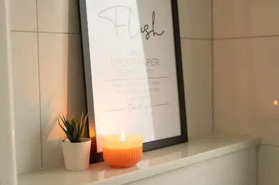 a candle sitting on a shelf next to a framed document at Hygge House Bled in Bled