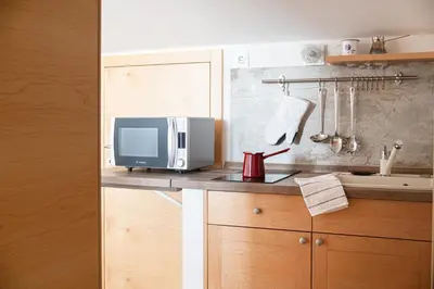 a kitchen with a microwave and a tv on a counter at Villa Azul in Kojsko