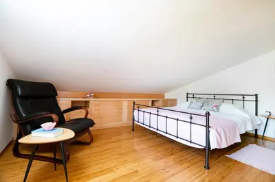 a bedroom with a bed and a chair and a table at Villa Azul in Kojsko