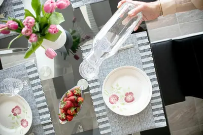 a table with plates and a bowl of strawberries on it at Villa Azul in Kojsko