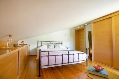 a bedroom with a bed in the middle of a room at Villa Azul in Kojsko