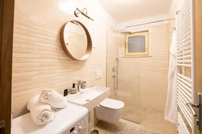 a bathroom with a sink and a toilet and a mirror at Villa Azul in Kojsko