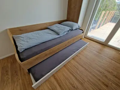 a bed in a room next to a window at Platinum Bled in Bled