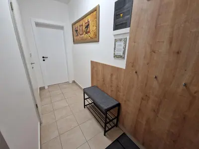 a small room with a bench and a wooden door at Platinum Bled in Bled