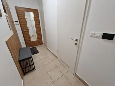 a hallway with a door and a stool in front of it at Platinum Bled in Bled