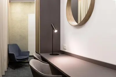 a waiting room with a mirror and chairs at Garni Hotel Cirman in Ljubljana