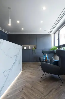 a living room with a marble counter and chairs at Garni Hotel Cirman in Ljubljana