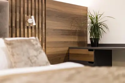 a living room with a chair and a table with a plant at Garni Hotel Cirman in Ljubljana