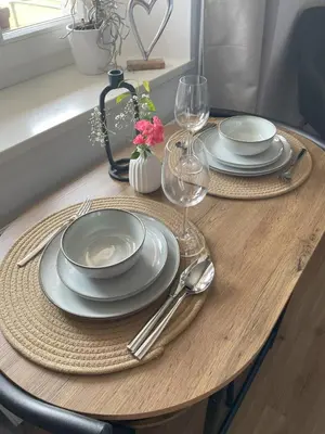 a wooden table with plates and wine glasses on it at Ami's House Castle View in Bled