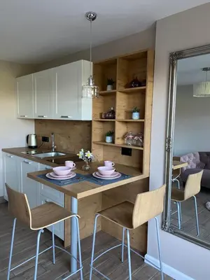 a kitchen with a table with chairs and a sink at Ami's House Castle View in Bled