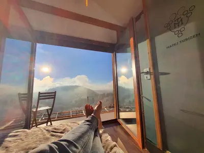 a person laying on a bed looking out of a window at Holiday home in Mirna Kranjska Krain 42906 in Mirna