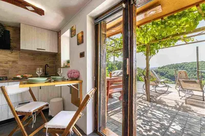 a kitchen with a table and chairs and a balcony at Holiday home in Mirna Kranjska Krain 42906 in Mirna