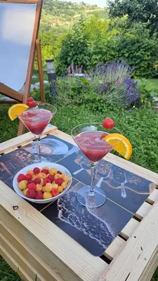 two wine glasses and a bowl of fruit on a table at Holiday home in Dvor Kranjska Krain 42901 in Dvor