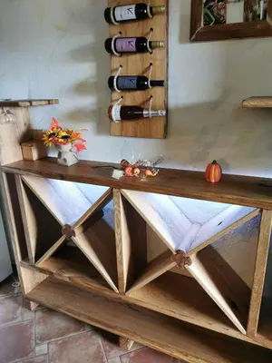 a wooden table with a bunch of wine bottles at Holiday home in Dvor Kranjska Krain 42901 in Dvor