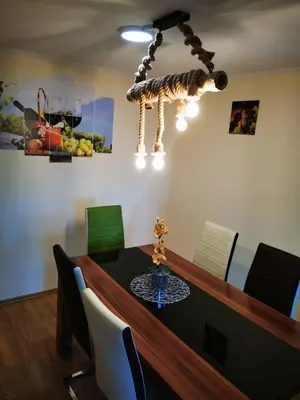 a dining room with a table with chairs and a chandelier at Holiday home in Dvor Kranjska Krain 42901 in Dvor