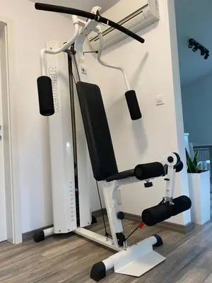a gym with a treadmill and a chair with speakers at Apartma Fojana in Dobrovo