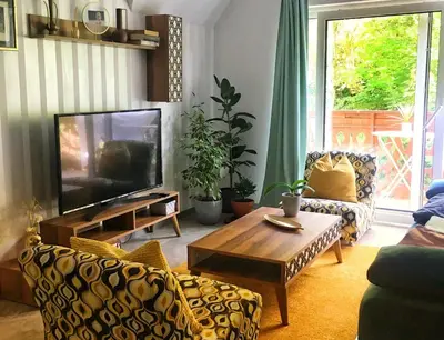 a living room with a tv and a couch and a table at Spacious nest between Maribor and Celje NiceHead in Loče pri Poljčanah