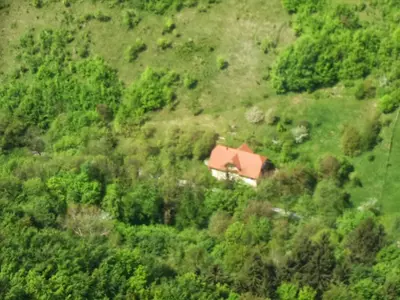 a house on the side of a hill with trees at Spacious nest between Maribor and Celje NiceHead in Loče pri Poljčanah