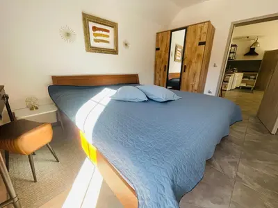 a bedroom with a large blue bed in a room at Spacious nest between Maribor and Celje NiceHead in Loče pri Poljčanah