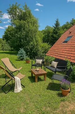 a group of chairs and a table in the grass at Spacious nest between Maribor and Celje NiceHead in Loče pri Poljčanah