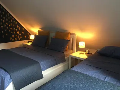 two beds sitting next to each other in a bedroom at Spacious nest between Maribor and Celje NiceHead in Loče pri Poljčanah