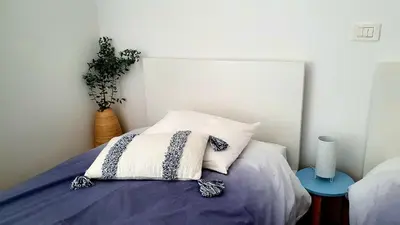 a bedroom with a bed with a pillow and a plant at Apartma Bovec Center in Bovec