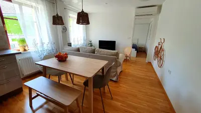 a living room with a table and a couch at Apartma Bovec Center in Bovec