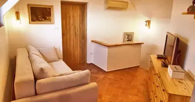 a living room with a couch and a television at Holiday home in Otocec Kranjska Krain 42903 in Otočec