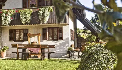 a house with a table and chairs in the yard at Holiday home in Otocec Kranjska Krain 42903 in Otočec