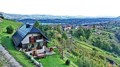 a house on top of a green hill at Holiday home in Otocec Kranjska Krain 42903 in Otočec