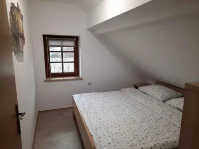 a bedroom with a white bed and a window at Holiday home in Semic Kranjska Krain 42896 in Semič
